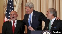 fghan President Ashraf Ghani (L) reacts as U.S. Secretary of State John Kerry (C) greets him and Chief Executive Abdullah Abdullah before a dinner at the State Department in Washington on March.