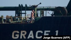 Crew members of Iranian supertanker Grace 1 walk on board off the coast of Gibraltar, August 15, 2019