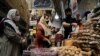 FILE PHOTO: Women wearing protective face masks shop at a bazaar following the outbreak of the coronavirus disease (COVID-19), in Tehran, Iran, July 8, 2020. 