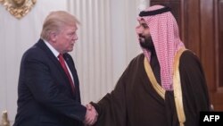 U.S. President Donald Trump (left) and Saudi Deputy Crown Prince Mohammed bin Salman shake hands in the State Dining Room before lunch at the White House on March 14.