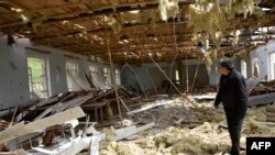 Nagorno-Karabakh -- An Armenian man walks inside a destroyed building in the village of Talish, some 80km north of Karabakh's capital Stepanakert, April 6, 2016