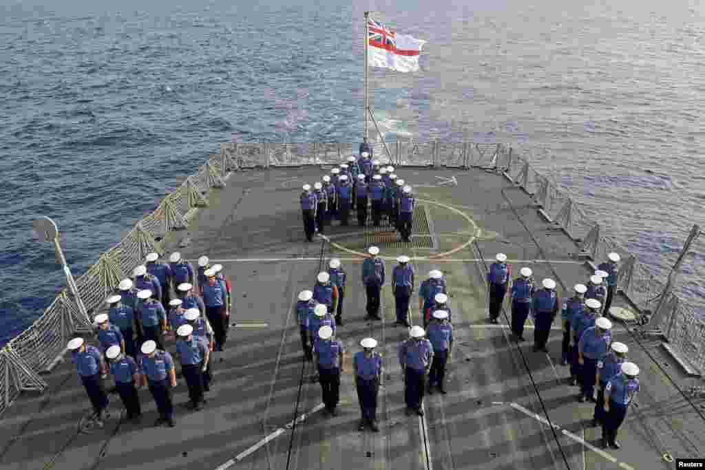 The crew of the Royal Navy frigate &quot;HMS Lancaster&quot; forms the word &quot;BOY&quot; on the deck to mark the birth of Britain&#39;s new prince. The ship was on patrol in the Caribbean Sea.