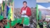 Residents walk past a poster of Turkmen President Gurbanguly Berdymukhammedov during an Independence Day parade in central Ashgabat in October 2008