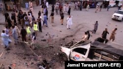 Pakistani security officials inspect the scene of a bomb blast in Quetta on July 30.