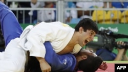 Georgia's Lasha Shavdatuashvili celebrates after defeating Israel's Sagi Muki during their men's -73kg judo contest bronze medal A match of the Rio 2016 Olympic Games in Rio de Janeiro on August 8, 2016.