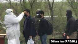 Қаладан шыға берісте медициналық маман жұрттың дене қызуын өлшеп жатыр. 1 сәуір 2020 жыл. Көрнекі сурет.