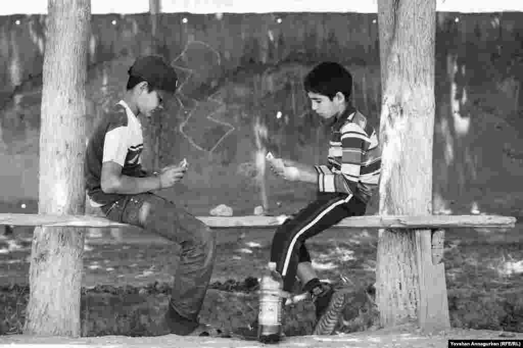 Young boys like Annagurban&#39;s nephew Begench (right) still while away the hours in Dostluk by playing cards, something Annagurban himself loved as a child. 