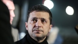 President Volodymyr Zelenskiy waits to meet the freed Ukrainians upon their arrival at the airport outside Kyiv on December 29.