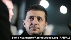 President Volodymyr Zelenskiy waits to meet the freed Ukrainians upon their arrival at the airport outside Kyiv on December 29.