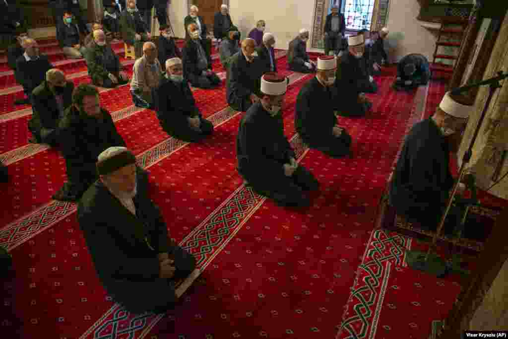 Muslim faithful line up for prayer behind imams wearing masks and respecting the social distance in Kosovo's capital, Pristina. (AP/Visar Kryeziu)