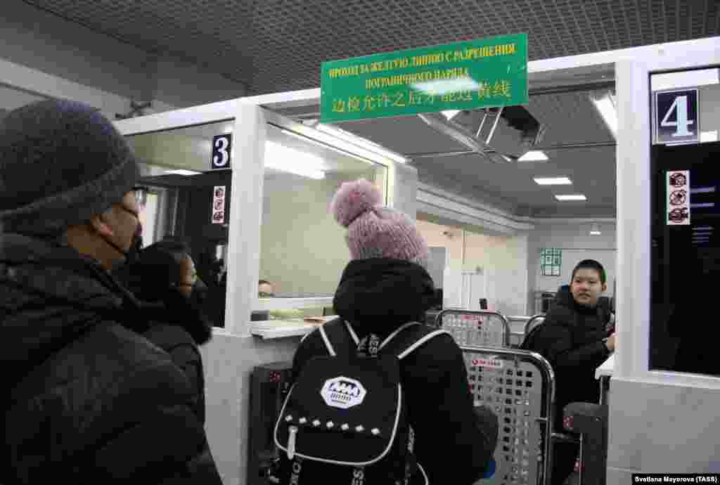 BLAGOVESHCHENSK, RUSSIA - FEBRUARY 1, 2020: Chinese citizens passing through a temporary corridor opened at a border checkpoint between Blagoveshchensk and Heihe. Temporary corridors are opened to return Russian and Chinese citizens to their countries as the Russian government orders to close the border with China as a measure to prevent the coronavirus spread. All the people passing through the temporary corridor are tested for the virus. The 2019-nCoV pneumonia-like coronavirus outbreak began in Wuhan, China, in late December 2019.