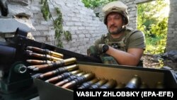 A Ukrainian soldier at his position on the front line in the Kharkiv area in June. "While we're supplying weapons, Ukrainians are dying, and their country is being destroyed," says former U.S. Lieutenant General Douglas Lute. "So I would like to see [weapons systems delivered] in much greater quantity, like an order of magnitude more, and much faster." 