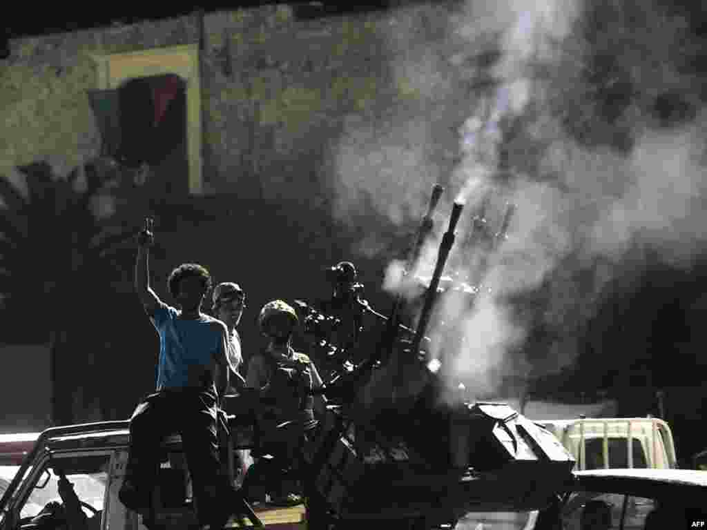 Jubilant rebels celebrate in the newly named Martyrs' Square, formerly known as Green Square, in Tripoli.