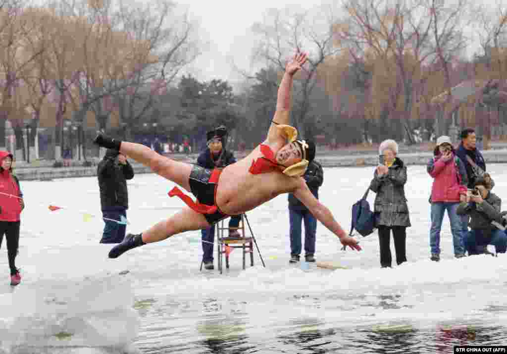 A man dives into a partly frozen lake in Shenyang, in China&#39;s northeastern Liaoning Province. (AFP/Stringer)