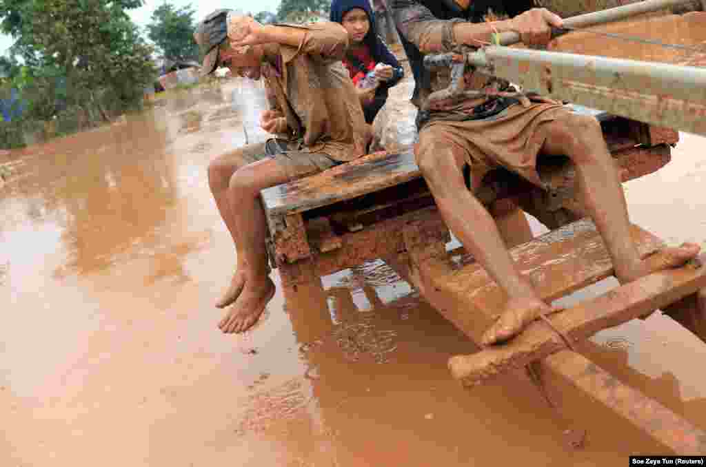 A man washes his face during a flood after the Xepian-Xe Nam Noy hydropower dam collapsed in Attapeu Province, Laos. More than 1,000 people are reportedly unaccounted for in the disaster. (Reuters/Soe Zeya Tun)