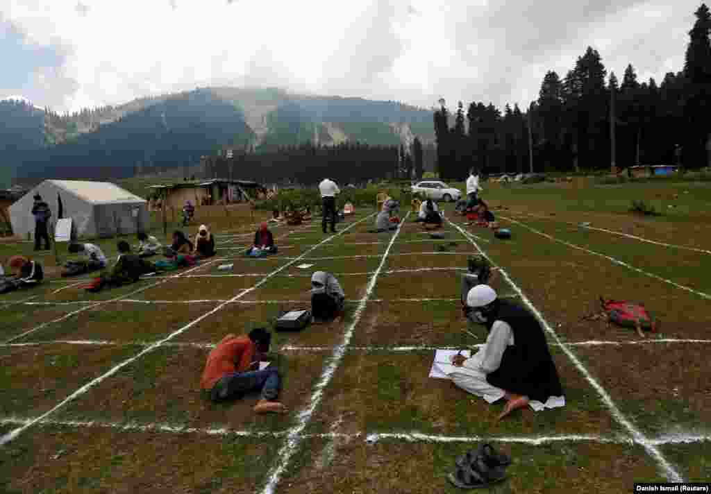 Teachers and children observe physical distancing during an outdoor class amid the scenic Doodhpathri hill station in central Kashmir&#39;s Budgam district on August 24.