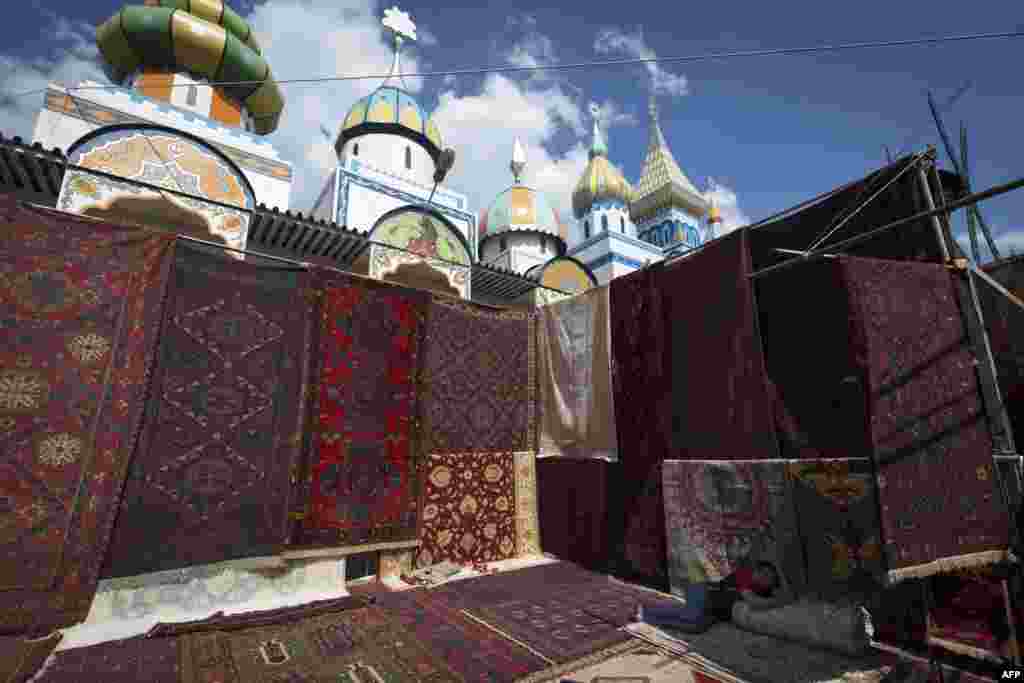 A man sells carpets at the Izmailovo flea market in Moscow, (AFP/Joel Saget)