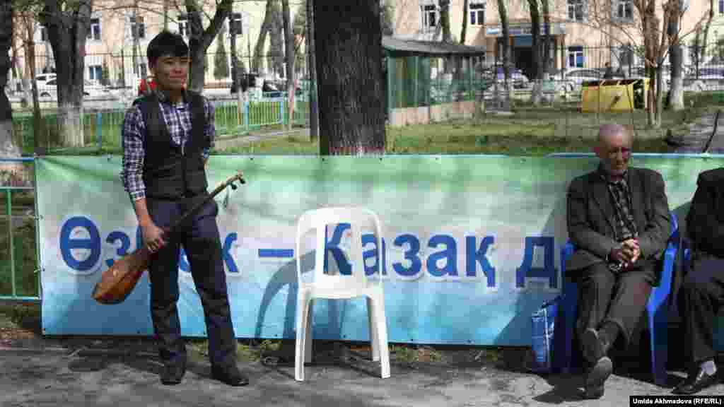 Молодой человек с домброй в парке, где казахи, проживающие в Ташкенте, отмечают Наурыз.