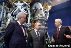 Russian President Vladimir Putin (center), Dmitry Rogozin, and Igor Arbuzov (right), CEO of the rocket engine manufacturer Energomash, visit an Energomash factory near Moscow in April 2019.