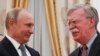 Russian President Vladimir Putin (left) shakes hands with U.S. national-security adviser John Bolton in Moscow.