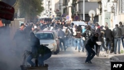 Protesters clash with security forces outside the Interior Ministry in Tunis on February 7. 