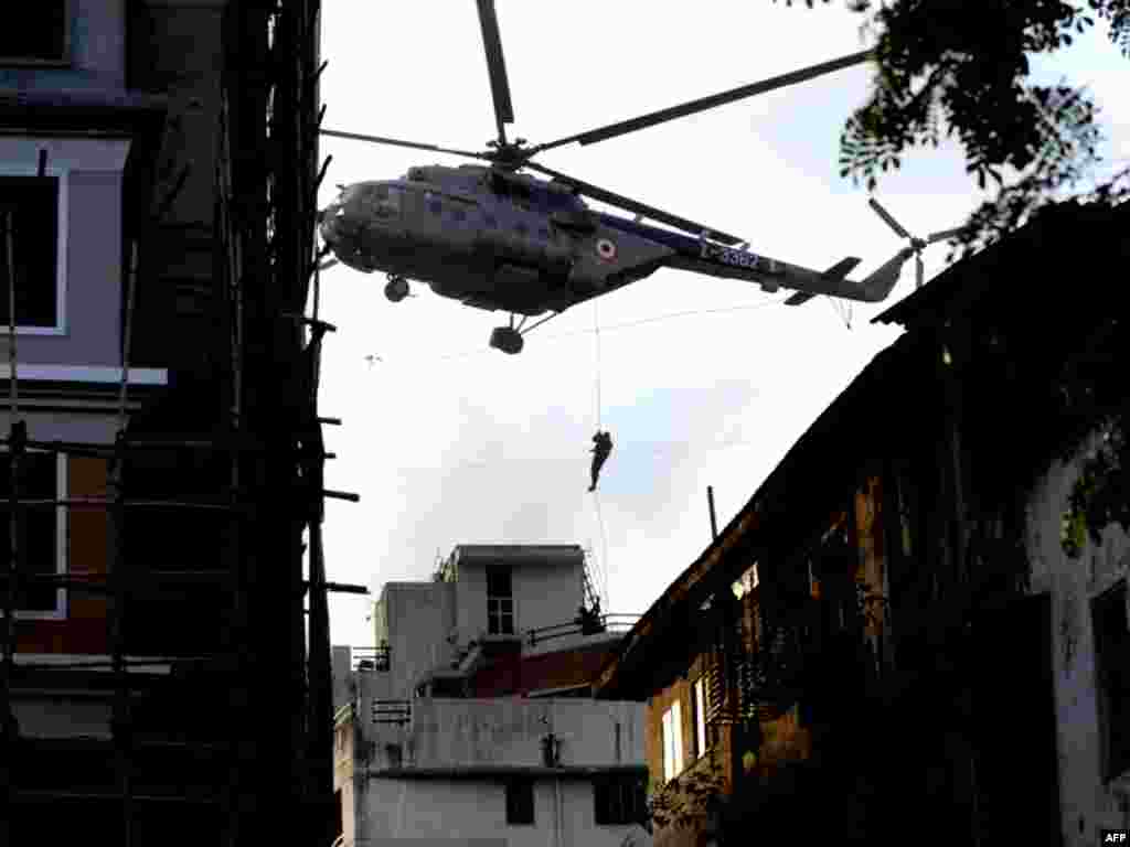 An Indian commando rappels from a helicopter during an operation at Nariman House.