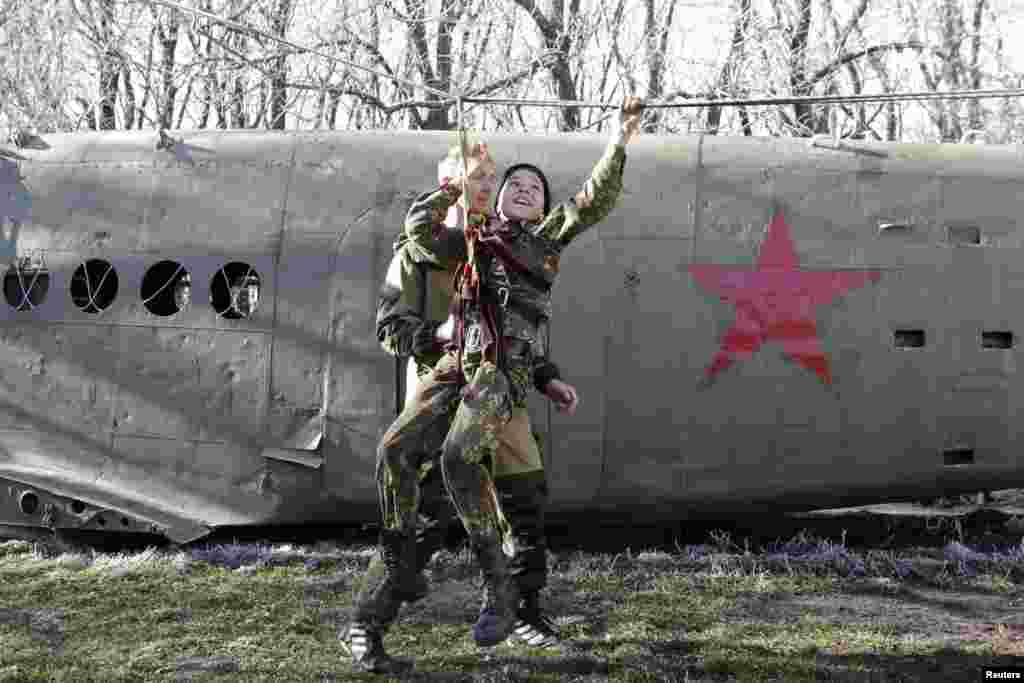 A student from the General Yermolov Cadet School crosses an obstacle during a competition between school classes in the southern Russian city of Stavropol. (Reuters/Eduard Korniyenko)