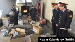 FILE: Officers of Tajikistan's Drug Control Agency burn seized drugs in Dushanbe.