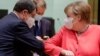 Cypriot President Nicos Anastasiades and Germany's Chancellor Angela Merkel bump elbows at the start of the first face-to-face EU summit since the coronavirus disease (COVID-19) outbreak, in Brussels, Belgium July 17, 2020.