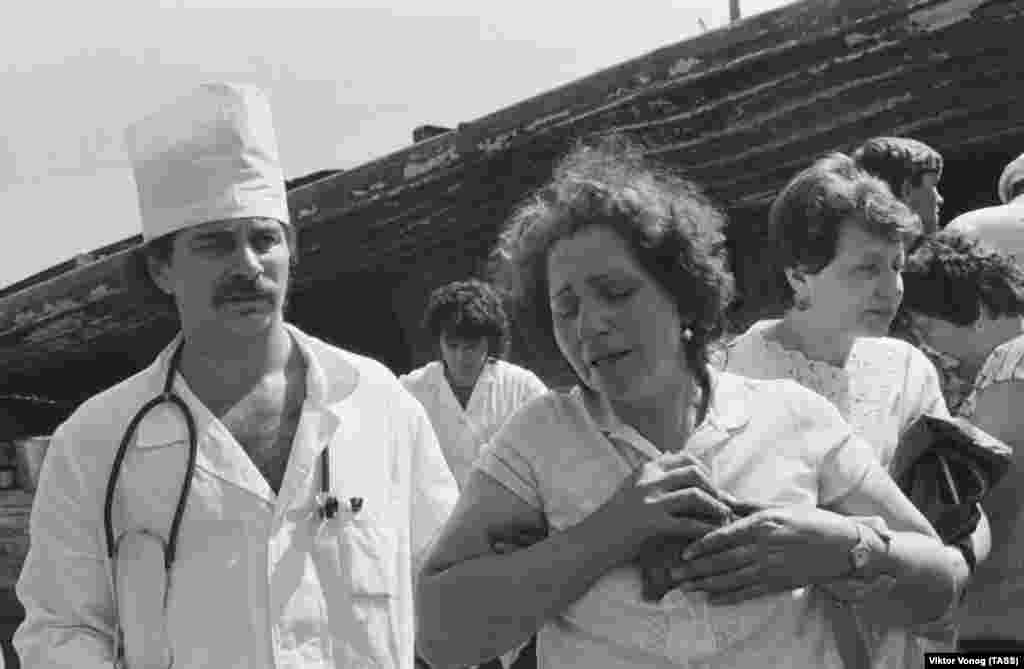 Relatives and friends of the victims are pictured at the scene of the explosion.