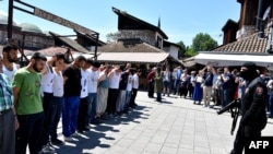 People gather in the historical center of Sarajevo, on May 31, 2017, in a re-enactment of inmates being imprisoned at the "Manjaca" concentration camp during the wars of the early 1990s.