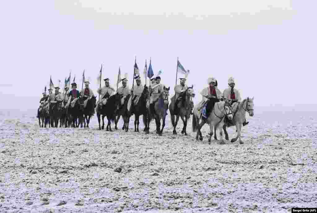 Men dressed as 1812-era French soldiers take part in a reenact of a battle near the Belarusian village of Bryli, about 115 kilometers east of the capital, Minsk, to mark the 206th anniversary of the Berezina battle during Napoleon&#39;s army retreat from Russia. About 50,000 people -- soldiers from both sides and civilians -- were killed during the crossing, which was effected under heavy Russian attack and saved Napoleon and his forces from capture. (AP/Sergei Grits)