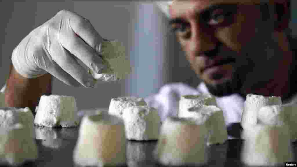 A technician inspects donkey cheese in the Sebian village of Kukujevci in the Zasavica nature reserve.