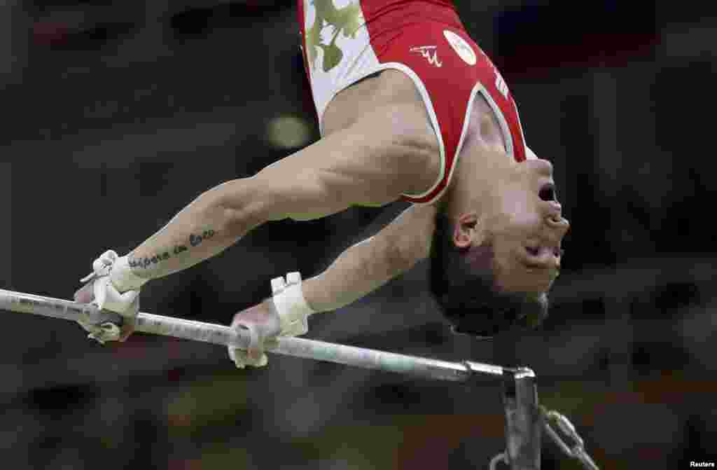 David Belyavsky of Russia competes on the horizontal bar. Russia returned to the podium for the first time since 2000 to take the silver medal in the men's gymnastics team competition, while Japan took the gold.