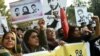 Pakistani rights activists hold images of bloggers who have disappeared during a protest in Lahore. 