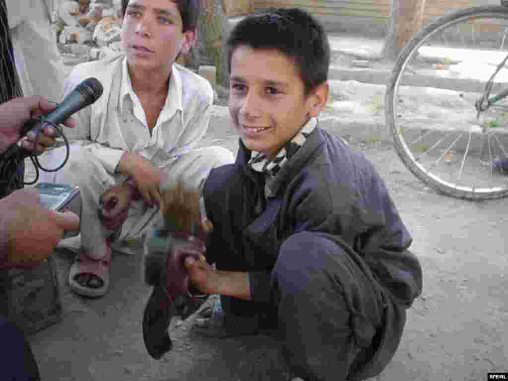 Young shoe cleaners in the streets of the Afghan capital, Kabul (RFE/RL) - "The most extreme forms of child labor can involve children being enslaved, separated from their families, exposed to serious hazards and illnesses, or left to look after themselves on the streets of large cities," the ILO reports.