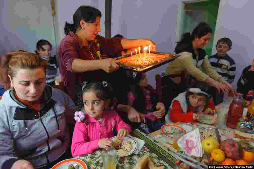 Ethnic Armenian and Azeri children attend a friend's sixth birthday party, where everyone shares a table with regional dishes.