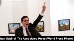 Mevlut Mert Altintas shouts after shooting Andrei Karlov, the Russian ambassador to Turkey, at an art gallery in Ankara, Turkey, December 19, 2016.<br />
<br />
The winning World Press Photo Of The Year, from Burhan Ozbilici of Associated Press, was also part of a series, "An Assassination in Turkey", which won the Spot News - Stories category. Ozbilici captured the moments before and after Altintas, an off-duty policeman, drew a handgun and shot Karlov at a photo exhibition.<br />
<br />
