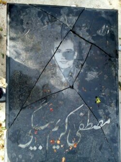 Iran – The destroyed gravestone of Mostafa Karimbeigi. (Courtesy of the family)