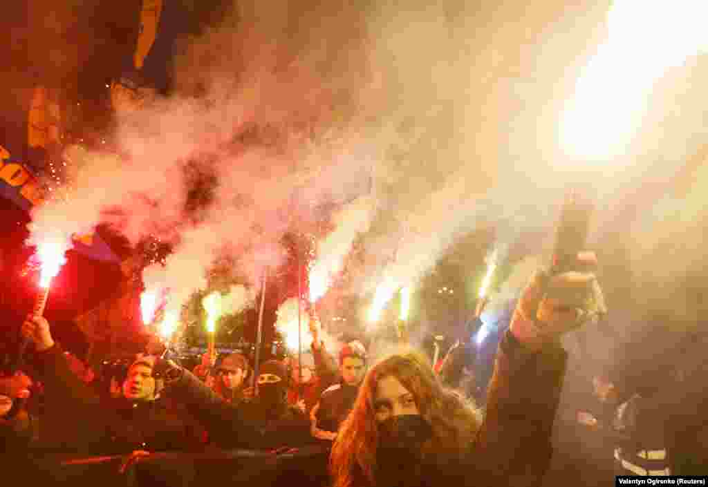 Activists of Ukrainian nationalist parties hold flares as they take part in a rally to mark the 109th anniversary of the birth of Stepan Bandera, one of the founders of the Organization of Ukrainian Nationalists (OUN), in Kyiv, on January 1. (Reuters/Valentyn Ogirenko)
