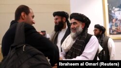 Members of a Afghan Taliban delegation gather to attend the signing of an agreement between the militant groups and U.S. officials in Doha earlier this year.