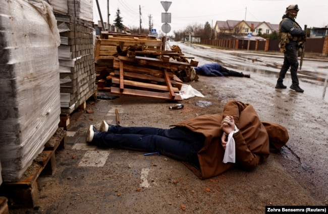 Bodies on a street in Bucha on April 3. "The general sentiment that [Putin's] been saying is that Ukraine doesn't have a right to exist. That Ukraine is a sort of international accident…. And therefore, he says, Ukraine doesn't have a right to exist," David Simon says. "At some level, that's different from saying Ukrainians don't have a right to exist."