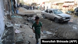 An boy walks near the site of a suicide bomb attack targeting a Shi'ite mosque in Kabul on September 29.