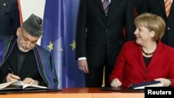 German Chancellor Angela Merkel (right) with Afghan President Hamid Karzai in Berlin.