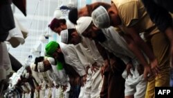 Pakistani Muslims perform a special "Taraweeh" evening prayer on the first day of the Muslim fasting month of Ramadan at a mosque in Karachi on June 6.