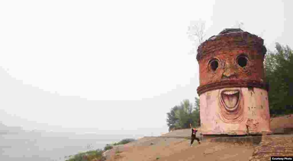 Nikita Nomerz appears next to his work titled &quot;The Big Brother&quot; in Nizhny Novgorod (2010)