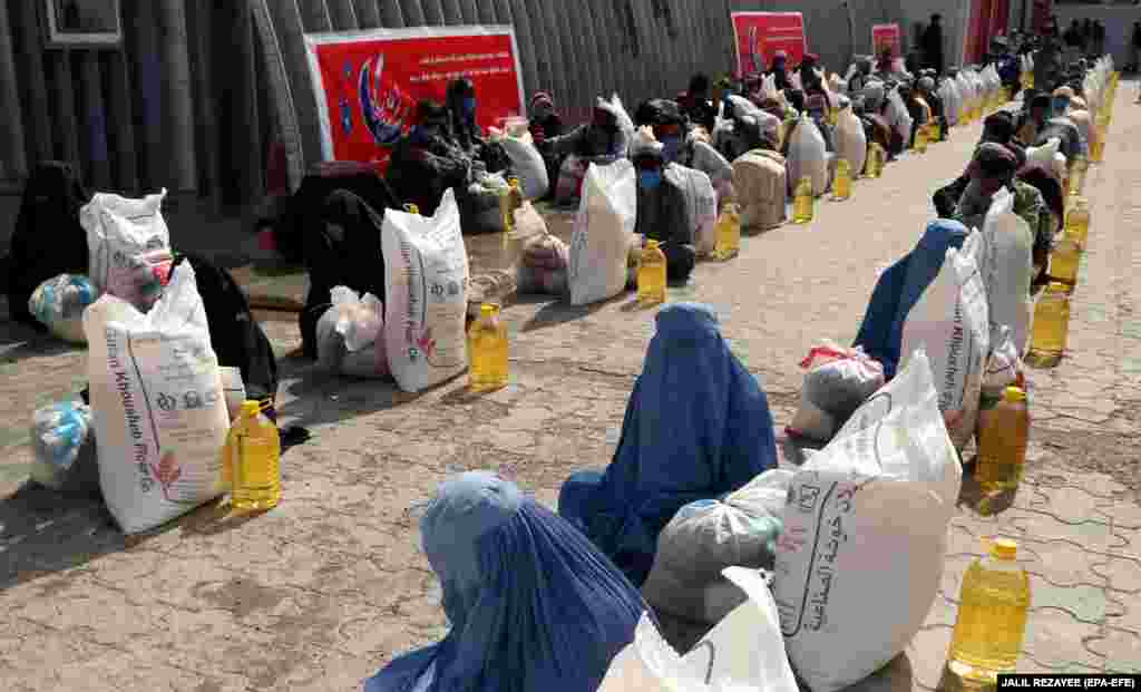 Afghan families receive free food rations distributed by traders during the Muslim holy month of Ramadan in Herat on May 18. (epa-EFE/Jalil Rezayee)