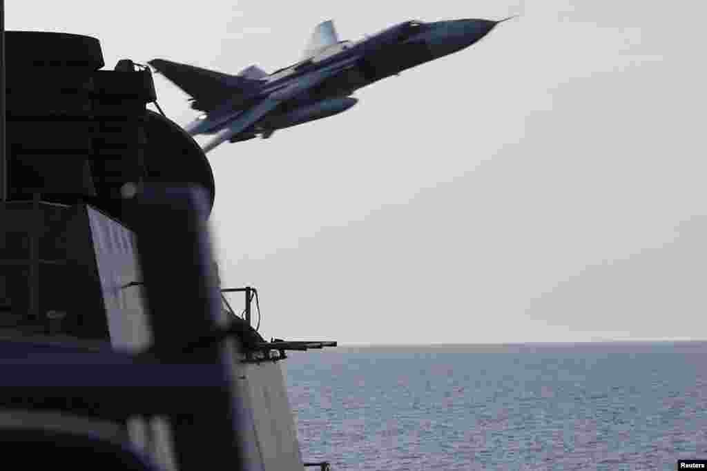 A U.S. Navy photo shows a Russian Sukhoi Su-24 attack aircraft making a very low pass close to the U.S. guided-missile destroyer USS Donald Cook in the Baltic Sea on April 12. Two Russian warplanes with no visible weaponry flew near the destroyer in what one U.S. official described as one of the most aggressive interactions in recent memory. (Reuters)