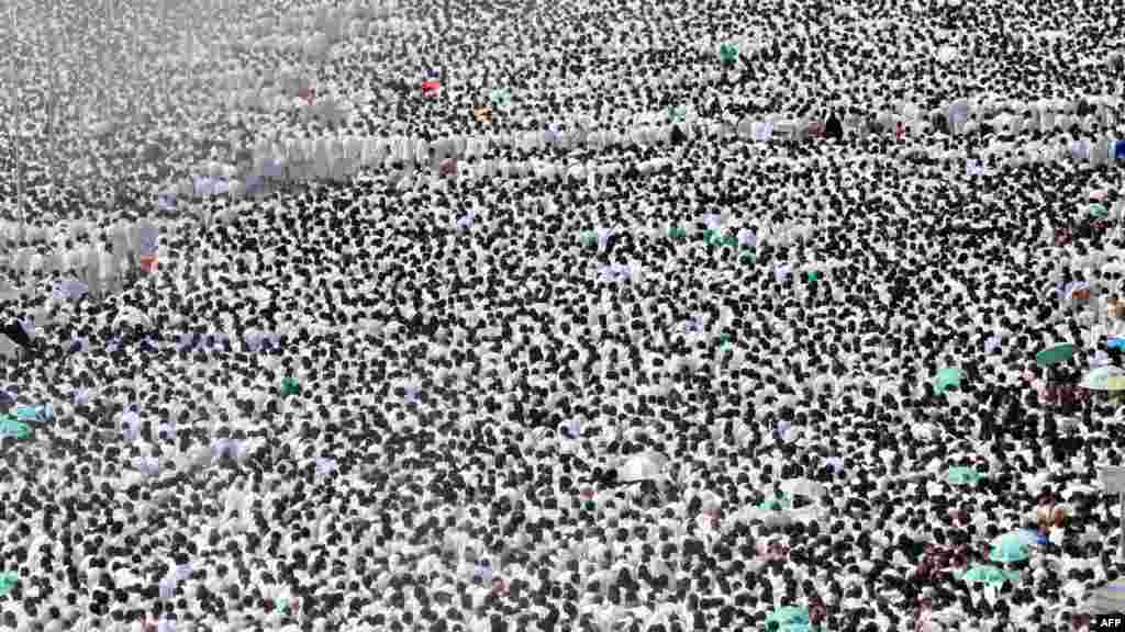 Pilgrims perform the noon prayer outside the Namera mosque in the plain of Arafat on the outskirts of the holy city of Mecca during the 2012 hajj.