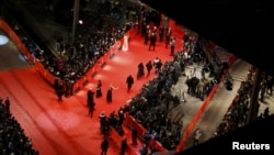 People arrive on the red carpet for the screening of "The Grandmaster" at the Berlinale on February 7.
